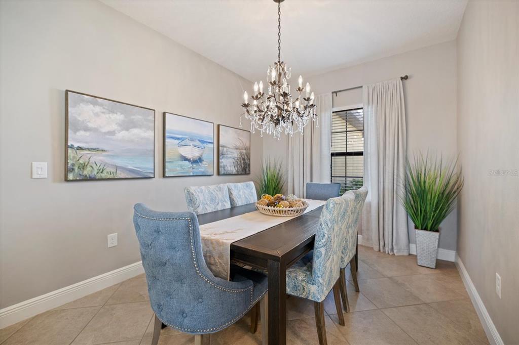 208 Brienza Loop Nokomis, FL 34275 - Photo 13 of 45 a view of a dining room with furniture window and wooden floor