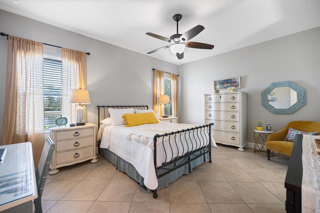 208 Brienza Loop Nokomis, FL 34275 - Photo 15 of 45 a bed room with a bed and a chandelier