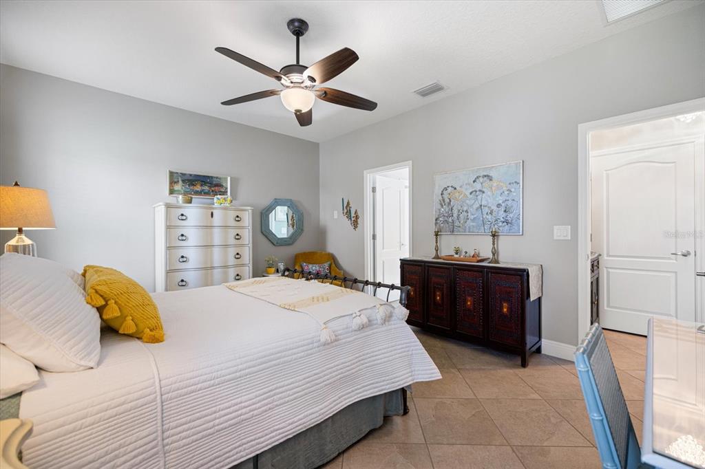 208 Brienza Loop Nokomis, FL 34275 - Photo 16 of 45 a bedroom with a bed and a chandelier