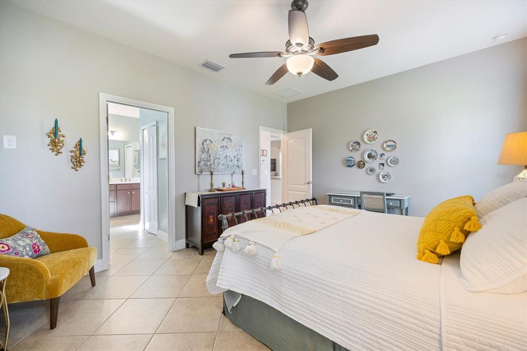 208 Brienza Loop Nokomis, FL 34275 - Photo 17 of 45 a bedroom with a bed and a chandelier