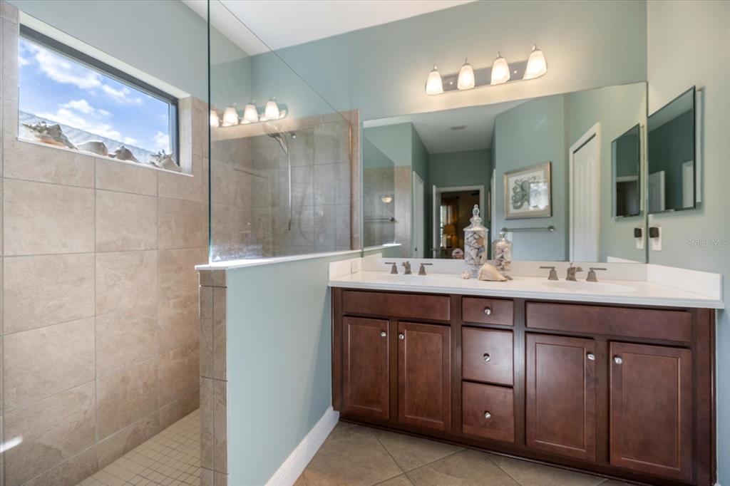 208 Brienza Loop Nokomis, FL 34275 - Photo 18 of 45 a bathroom with a double vanity sink and a mirror