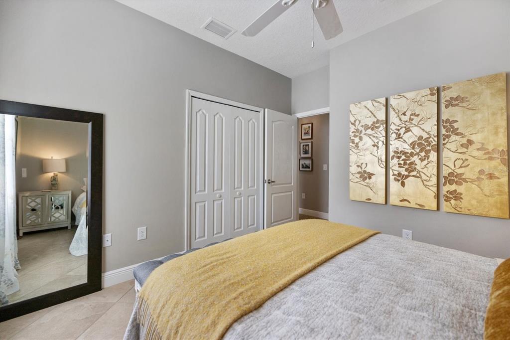 208 Brienza Loop Nokomis, FL 34275 - Photo 19 of 45 a bedroom with a large bed and a window