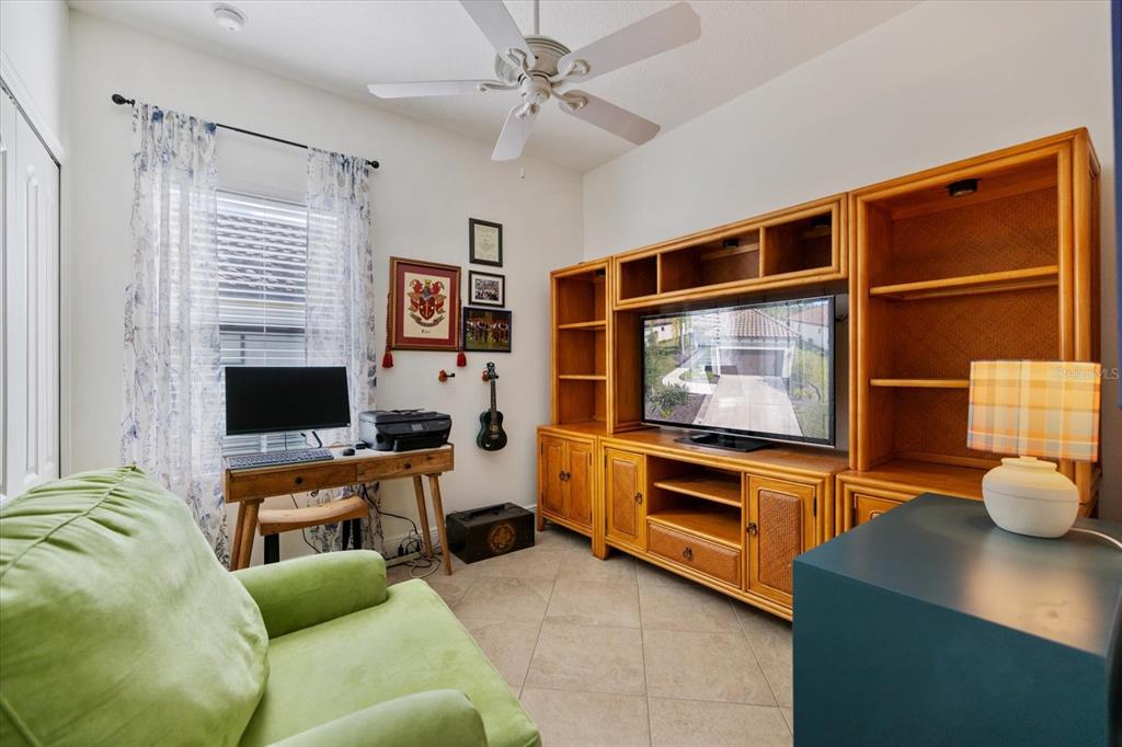 208 Brienza Loop Nokomis, FL 34275 - Photo 22 of 45 a living room with furniture a flat screen tv and kitchen view