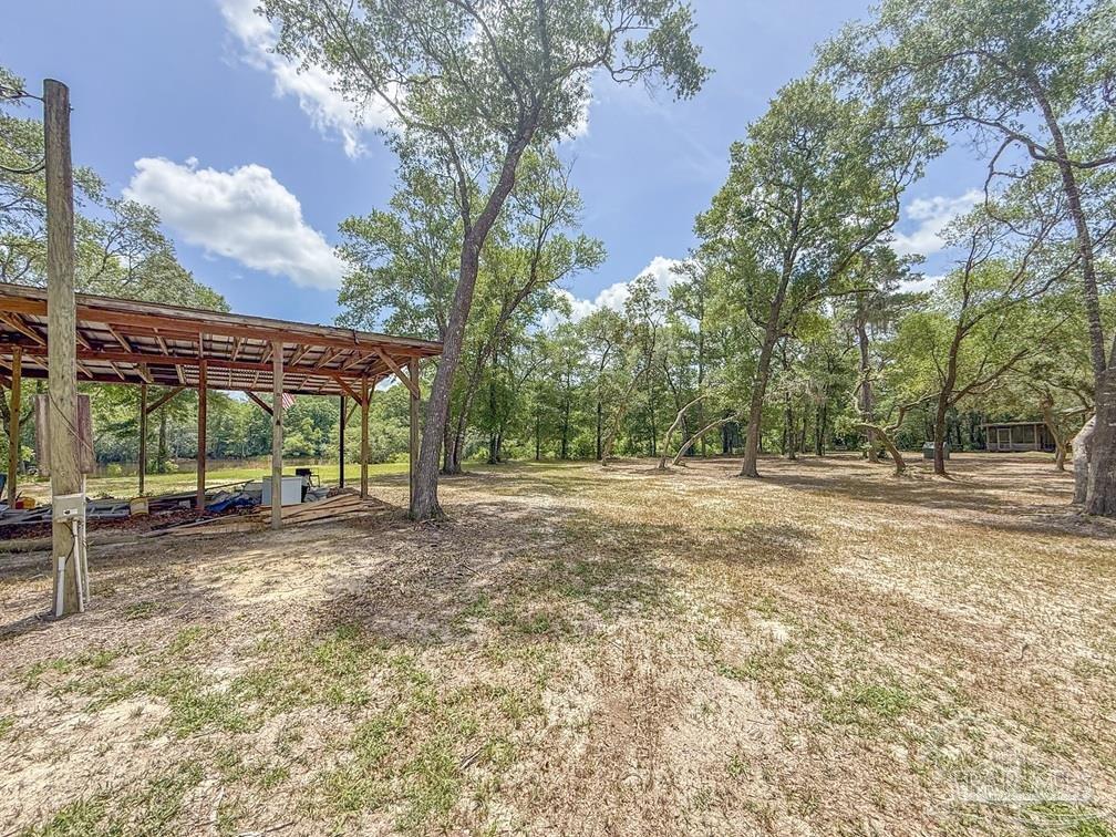 4020 Easy Street Holt, FL 32564 - Photo 16 of 19 a view of a yard with a tree