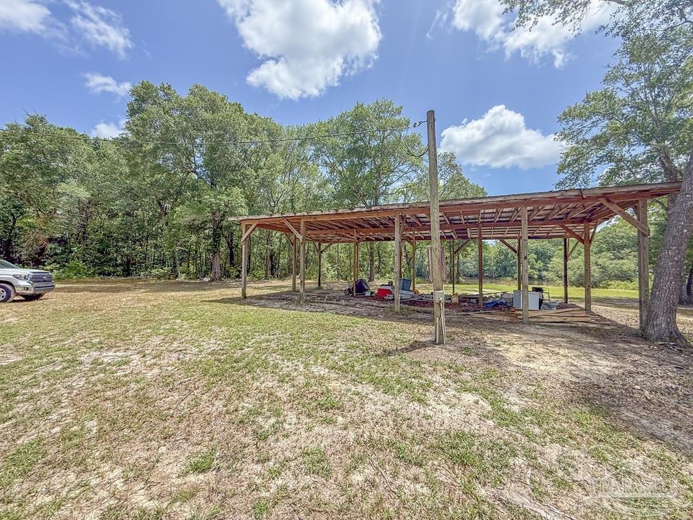 4020 Easy Street Holt, FL 32564 - Photo 17 of 19 a view of a house with a yard