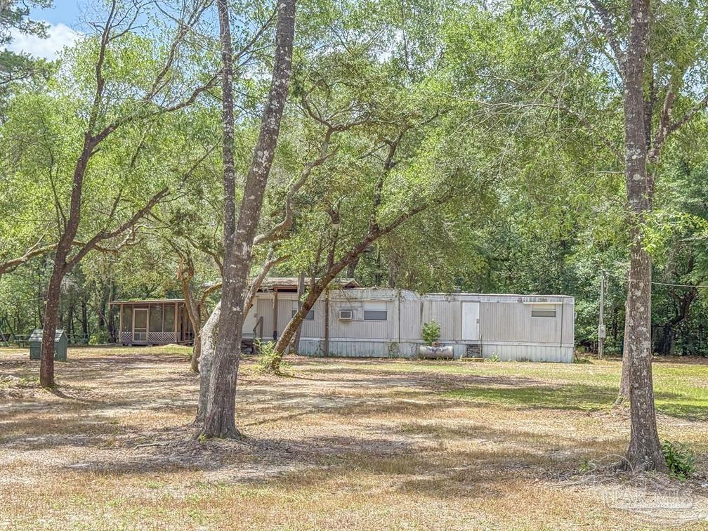 4020 Easy Street Holt, FL 32564 - Photo 8 of 19 a view of a house with snow on the tree