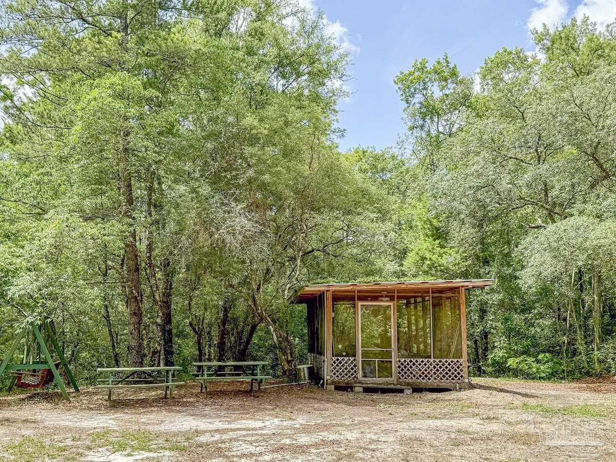4020 Easy Street Holt, FL 32564 - Photo 10 of 19 a front view of a house with garden