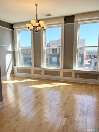 a view of a living room with a large window and chandelier