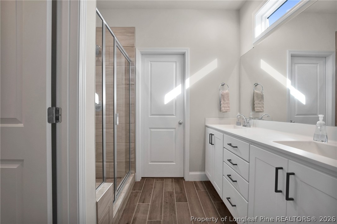 224 Timber Skip Drive Spring Lake, NC 28390 - Photo 15 of 30 a bathroom with a double vanity sink and mirror
