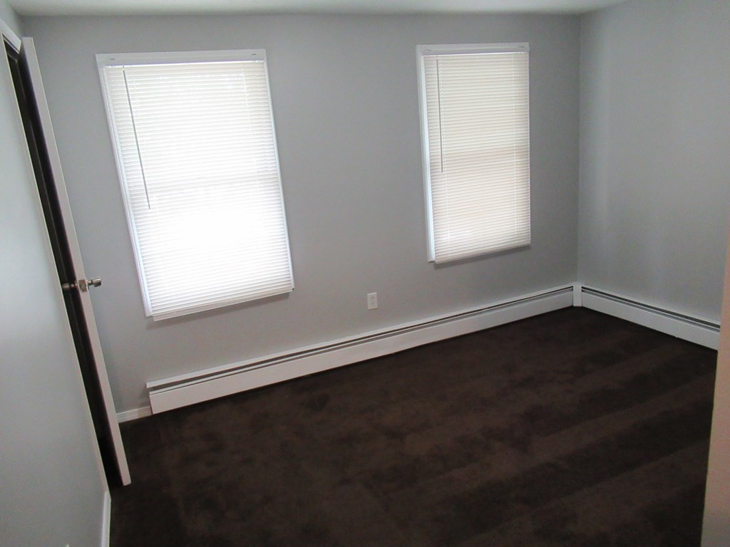 30 Clayton Street, Unit E Springfield, MA 01107 - Photo 16 of 27 an empty room with wooden floor and windows
