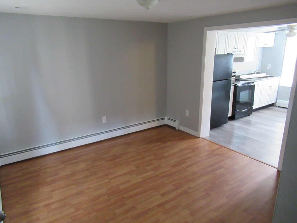 30 Clayton Street, Unit E Springfield, MA 01107 - Photo 4 of 27 a view of a kitchen with a sink stove cabinets and empty room