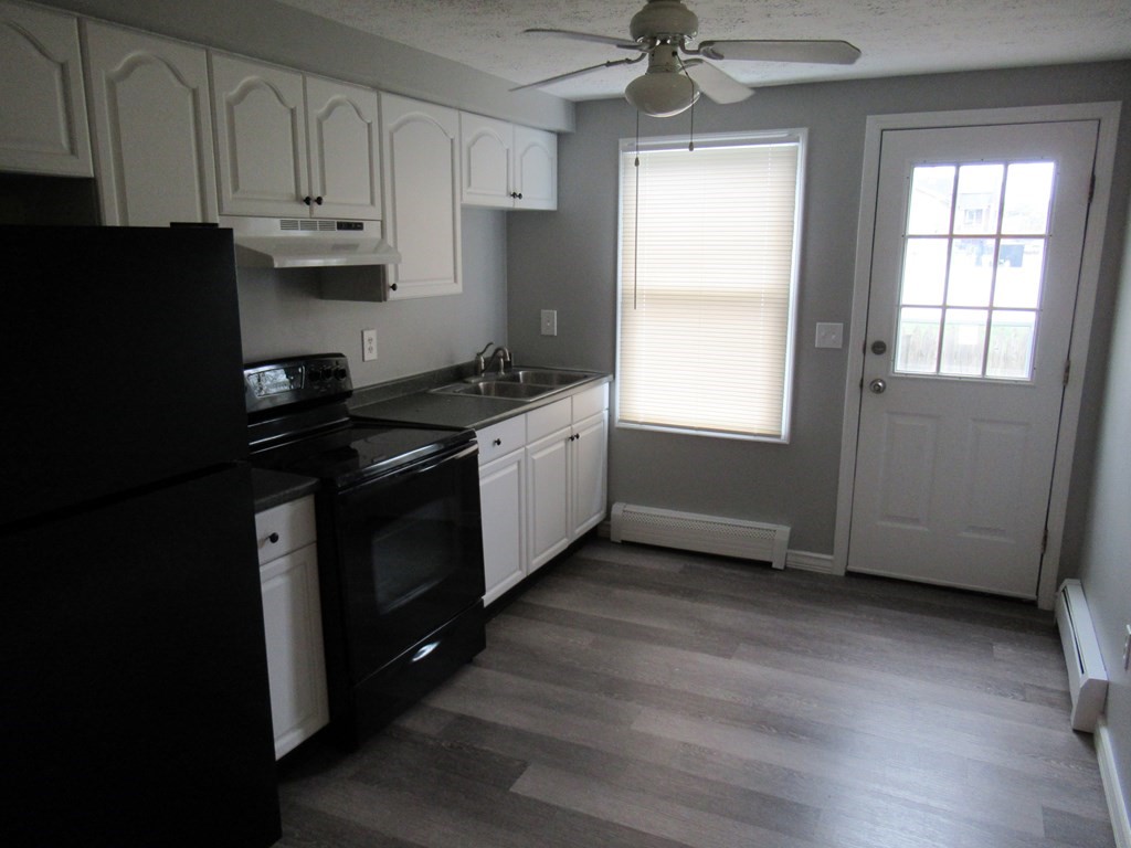 30 Clayton Street, Unit E Springfield, MA 01107 - Photo 5 of 27 a kitchen with stainless steel appliances granite countertop a stove a sink and a refrigerator