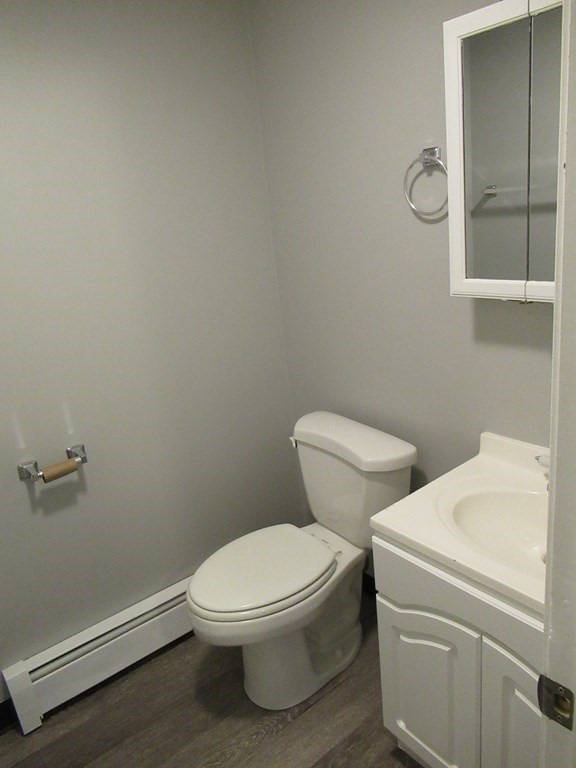 30 Clayton Street, Unit E Springfield, MA 01107 - Photo 8 of 27 a white toilet sitting next to a bathroom sink