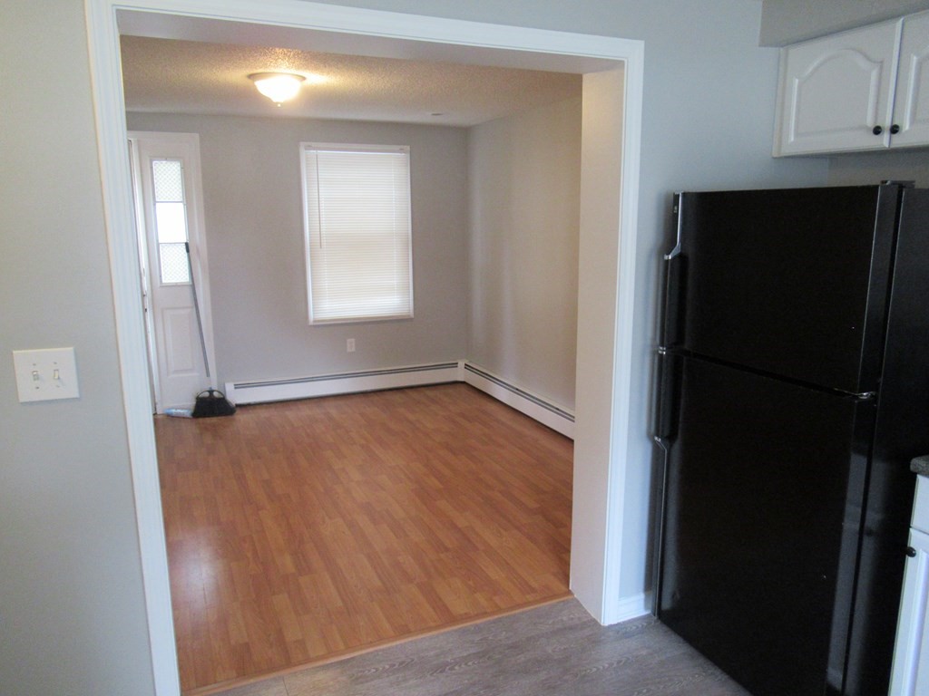 30 Clayton Street, Unit E Springfield, MA 01107 - Photo 10 of 27 a view of an empty room with wooden floor and a window