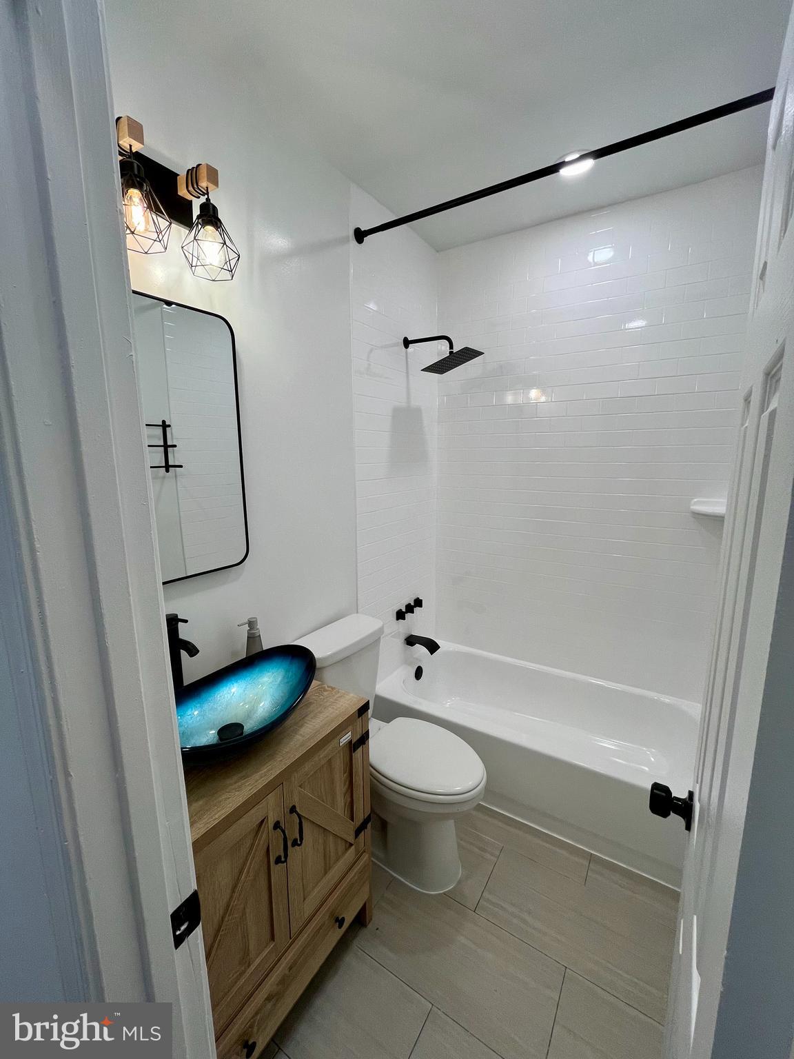 1718 West Virginia Avenue Northeast, Unit 1 Washington, DC 20002 - Photo 6 of 12 a bathroom with a granite countertop sink toilet and shower