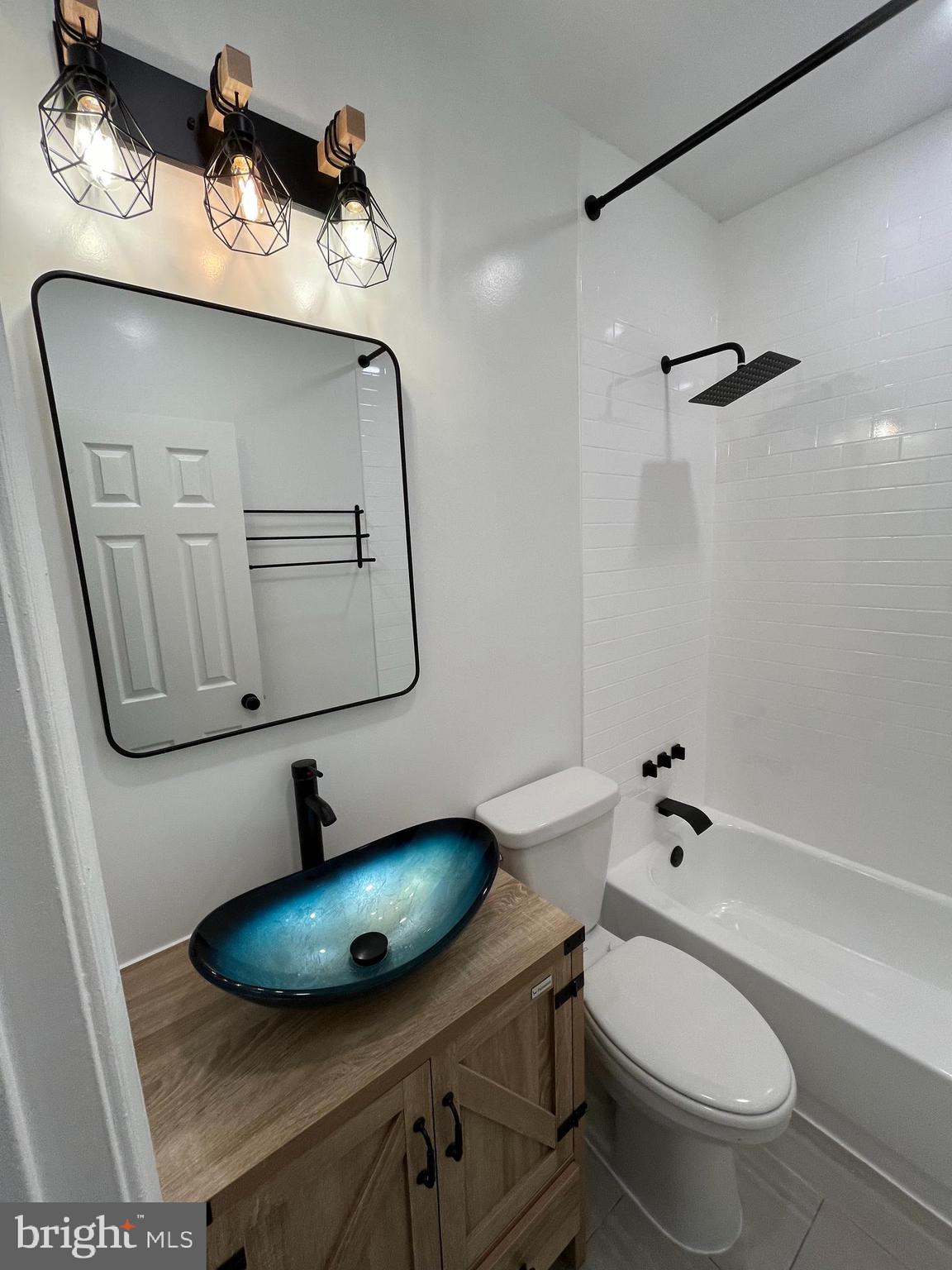 1718 West Virginia Avenue Northeast, Unit 1 Washington, DC 20002 - Photo 7 of 12 a bathroom with a toilet a sink and mirror