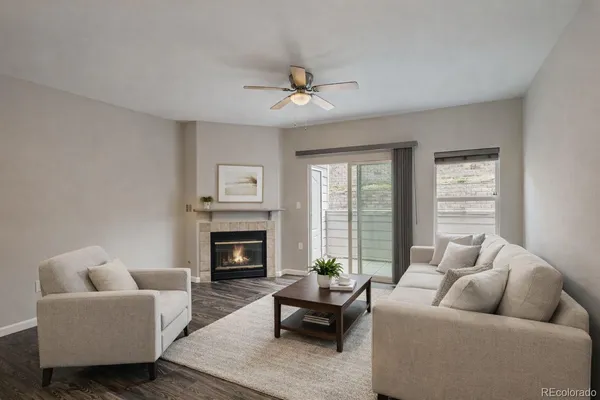 a living room with furniture fireplace and a large window