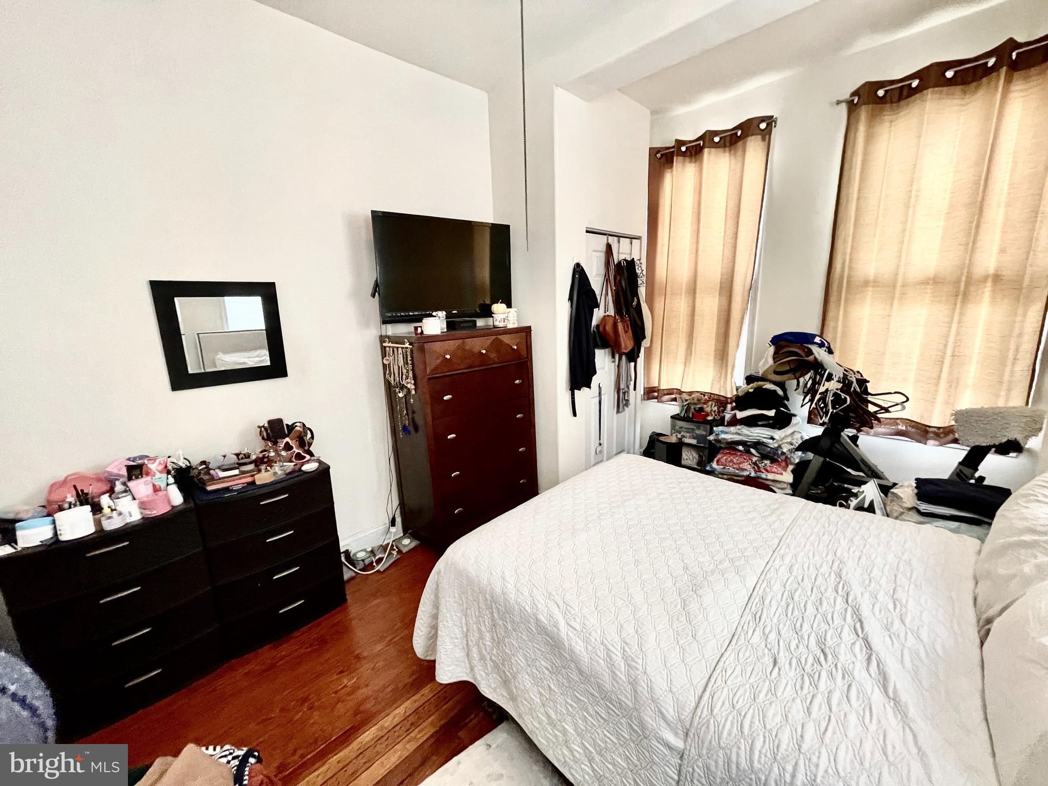 4217 Ridge Avenue, Unit 2 Philadelphia, PA 19129 - Photo 2 of 11 a bedroom with a bed and flat screen tv