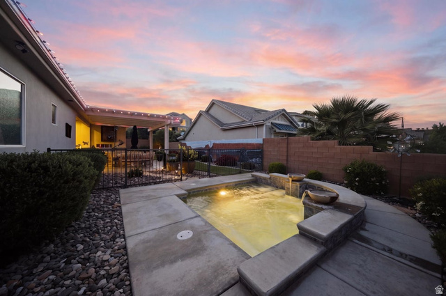 2829 East 1880th Street South St. George, UT 84790 - Photo 48 of 54 Pool at dusk with a fenced backyard and a patio