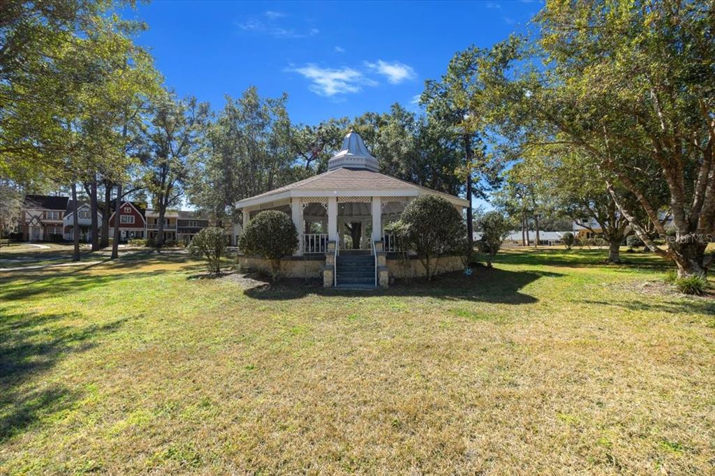 8830 Southwest 98th Place, Unit L Ocala, FL 34481 - Photo 14 of 17 a view of swimming pool with sitting area and garden