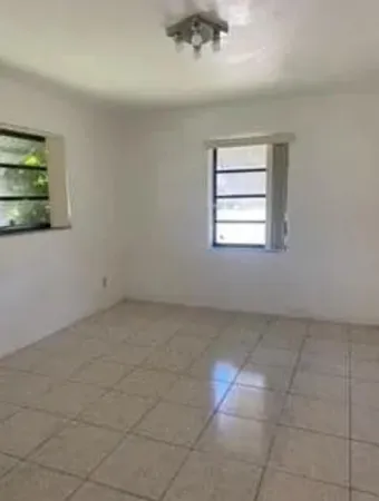 an empty room with a empty space and windows