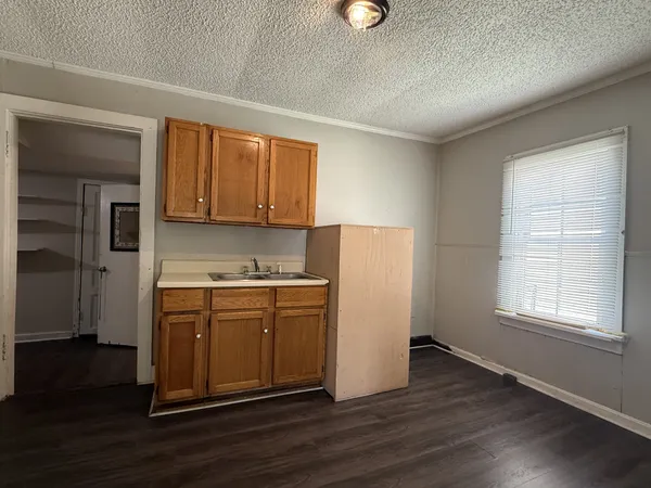 a kitchen with a refrigerator sink and cabinets
