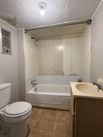 a bathroom with a sink a toilet and a bathtub