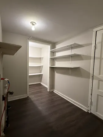 a view of a room with wooden floor and a window