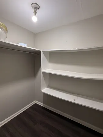 a view of an empty room with a ceiling fan