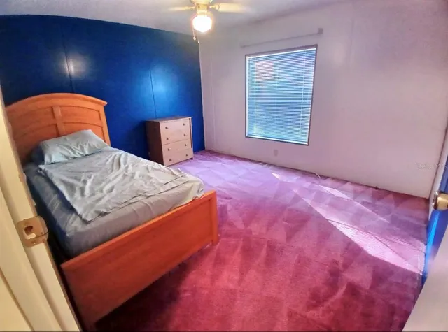 a bedroom with a bed and a mirror