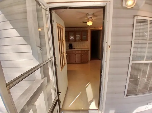 a view of a kitchen with fridge and a sink