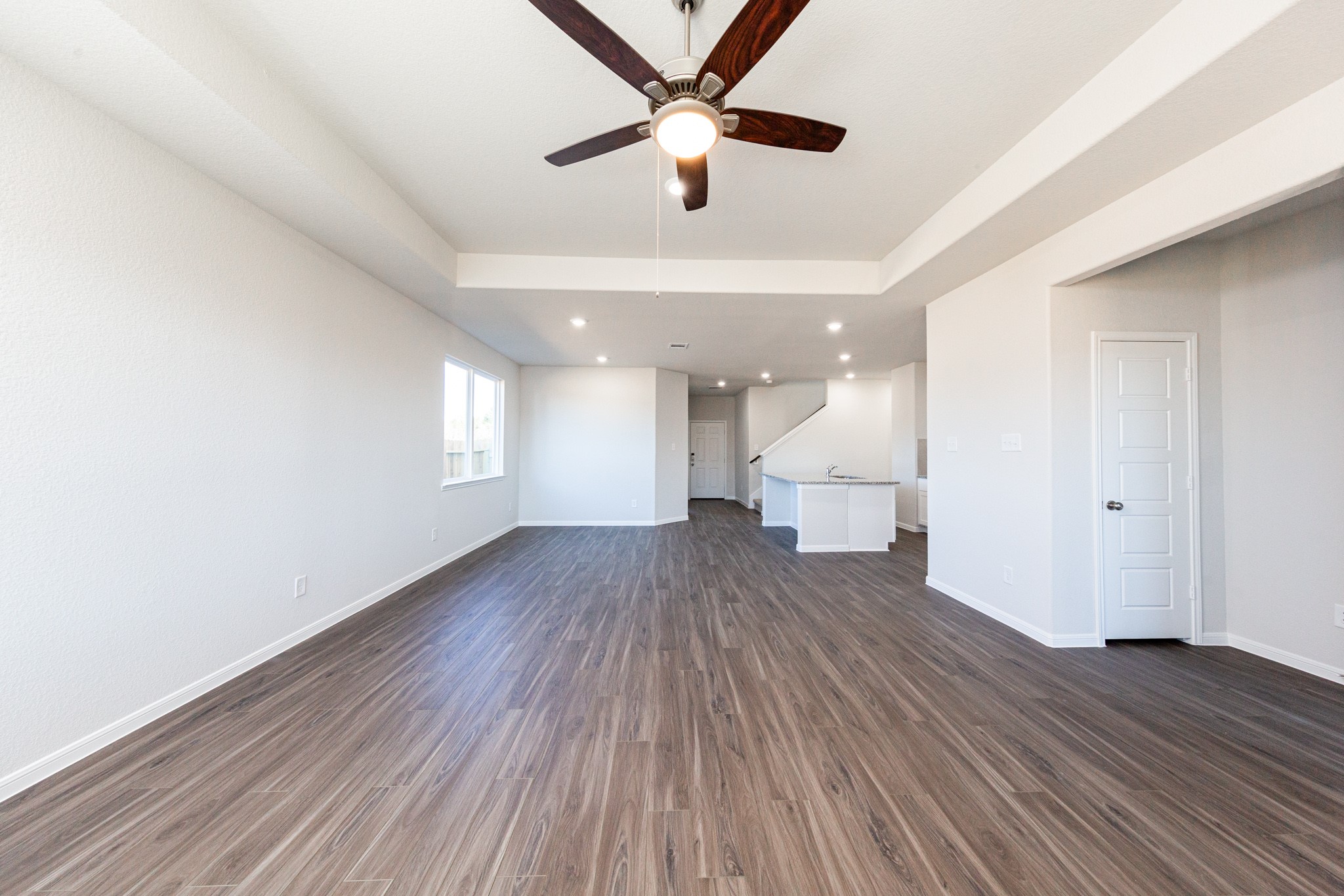 15627 Tranquil Pines Street Conroe, TX 77302 - Photo 11 of 27 a view of an empty room with wooden floor and a window