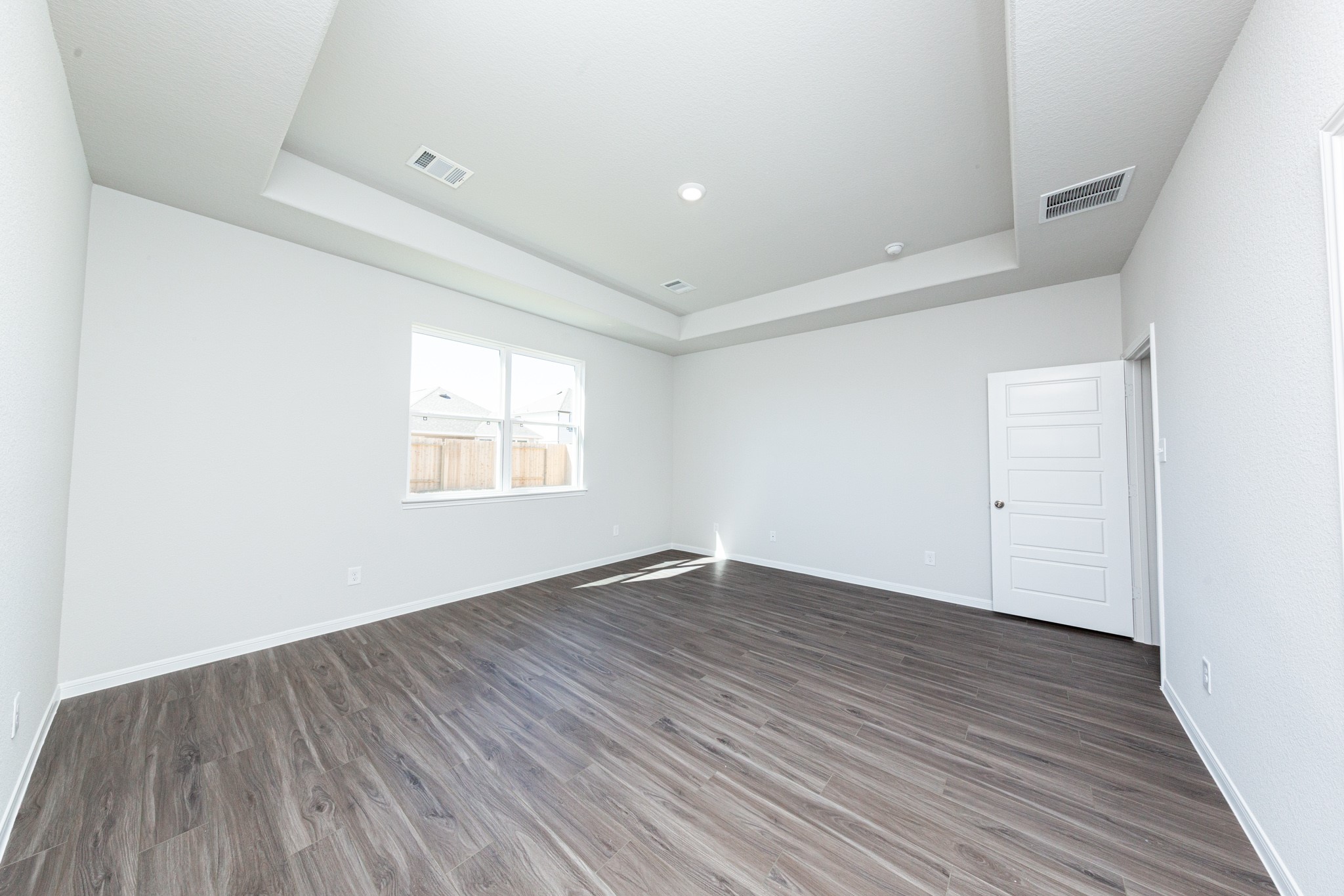 15627 Tranquil Pines Street Conroe, TX 77302 - Photo 13 of 27 an empty room with wooden floor and windows