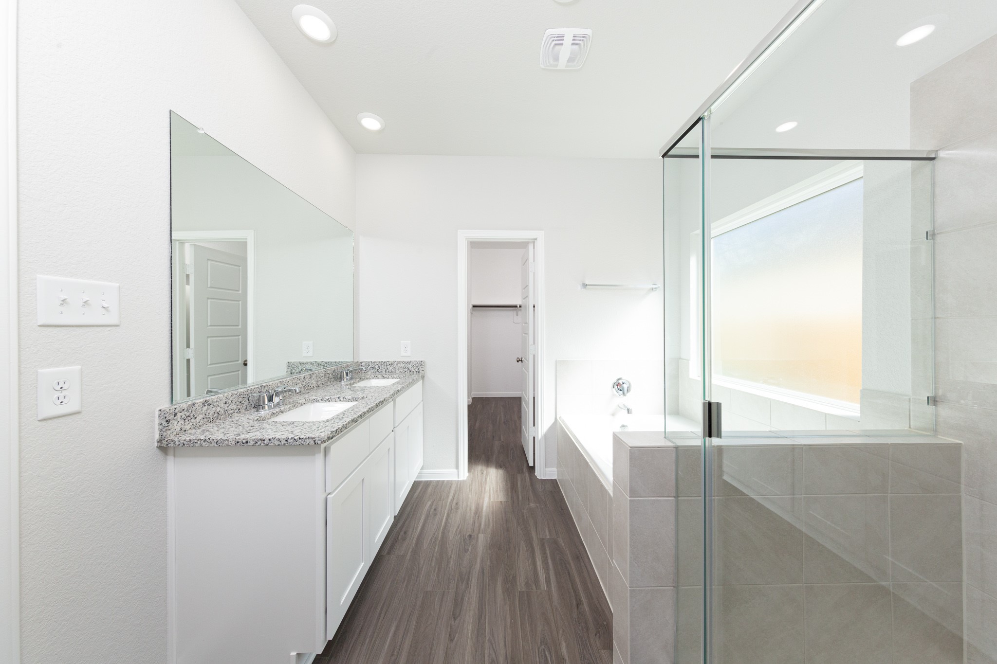 15627 Tranquil Pines Street Conroe, TX 77302 - Photo 14 of 27 a bathroom with a granite countertop sink a vanity and a large mirror