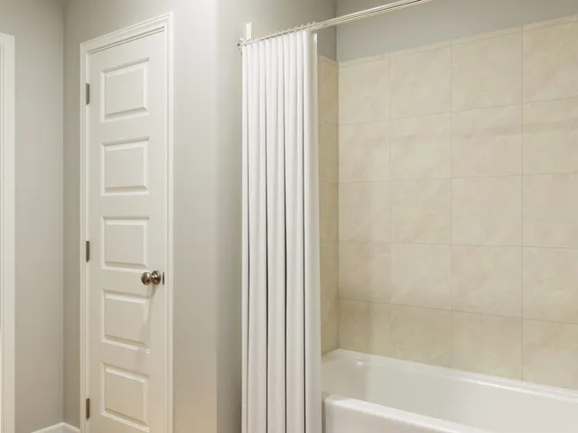 a bathroom with a granite countertop sink and a potted plant
