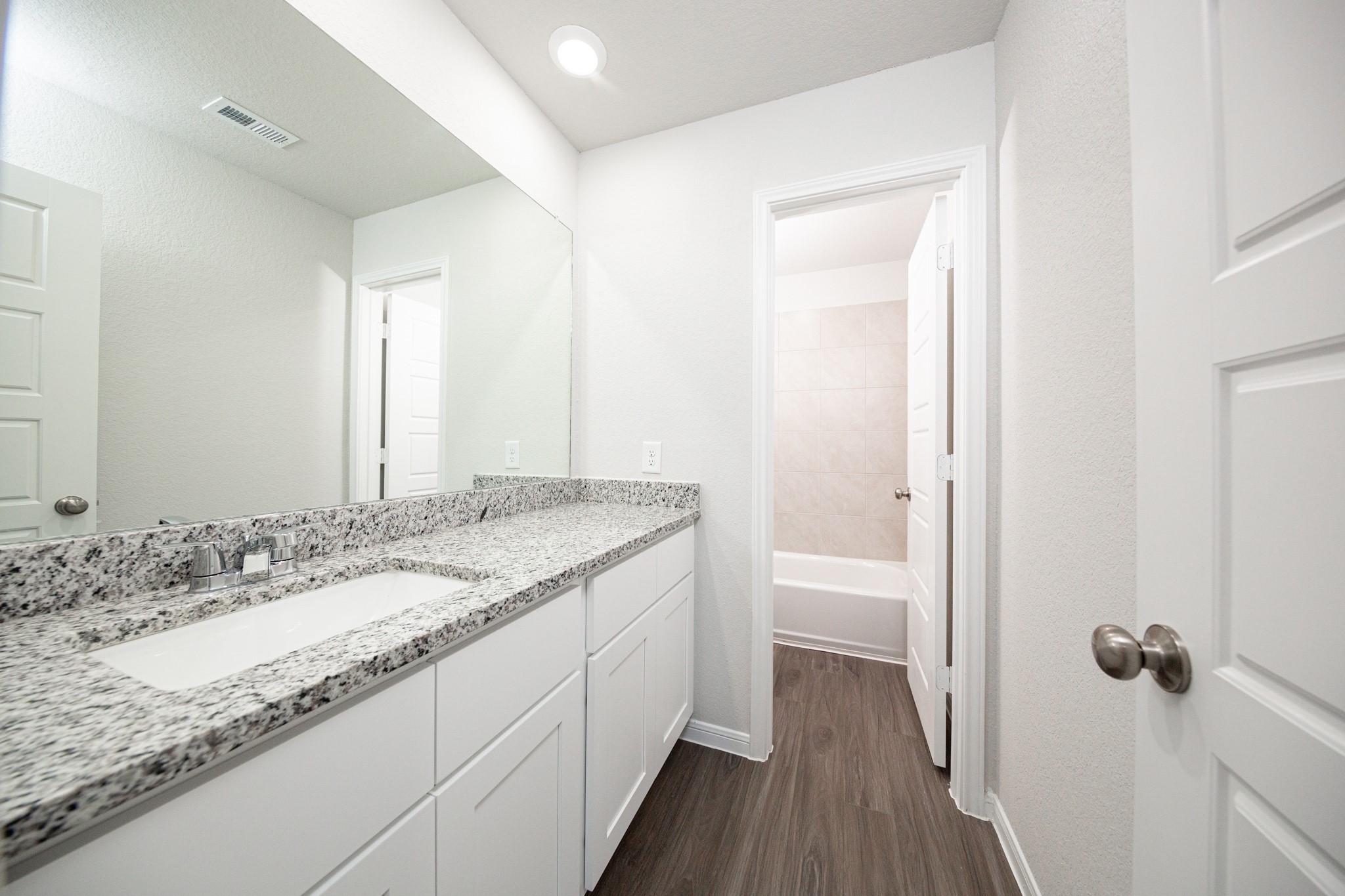 15627 Tranquil Pines Street Conroe, TX 77302 - Photo 17 of 27 a bathroom with a granite countertop sink and a mirror