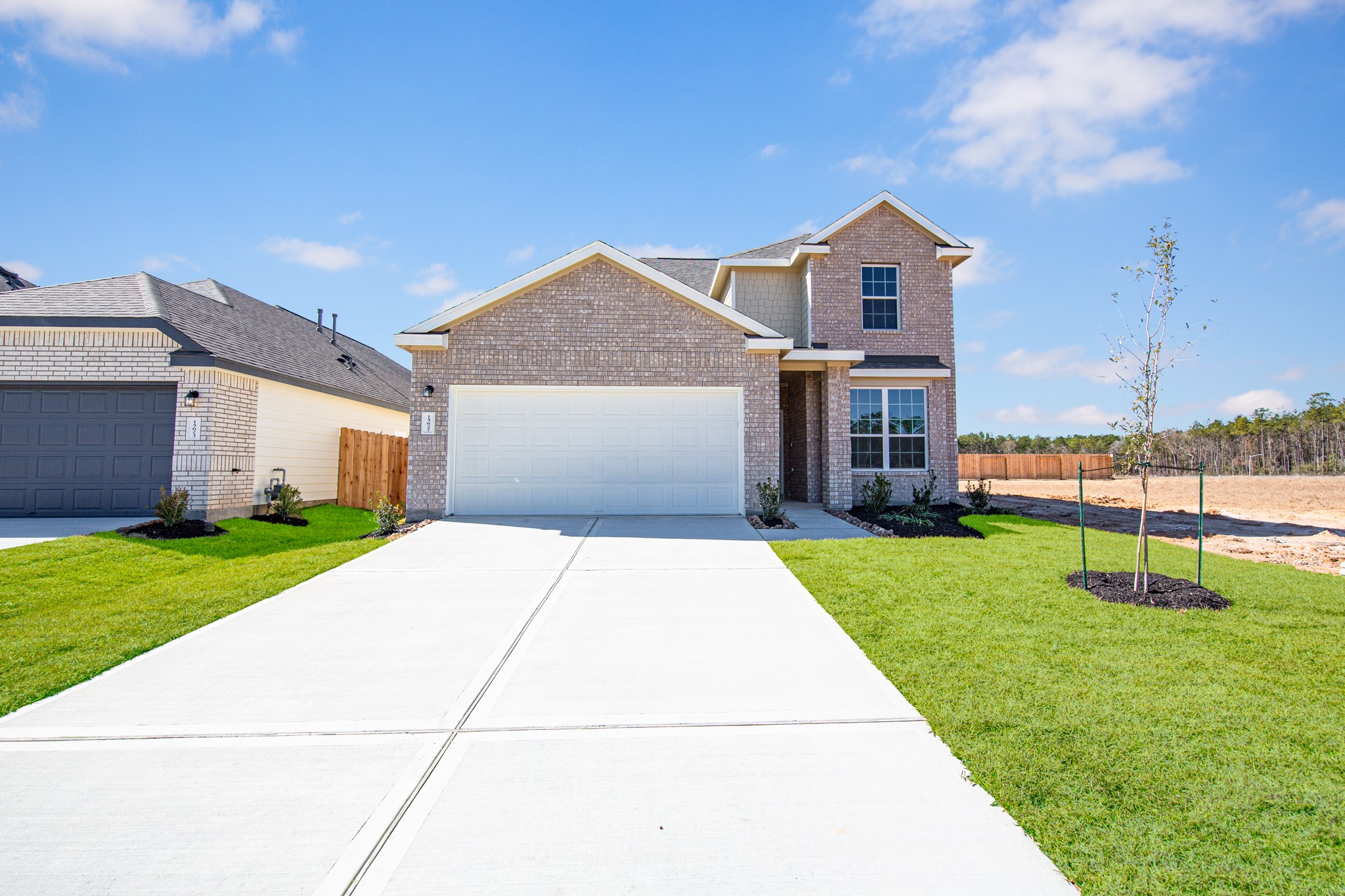 15627 Tranquil Pines Street Conroe, TX 77302 - Photo 3 of 27 a front view of a house with a yard and garage
