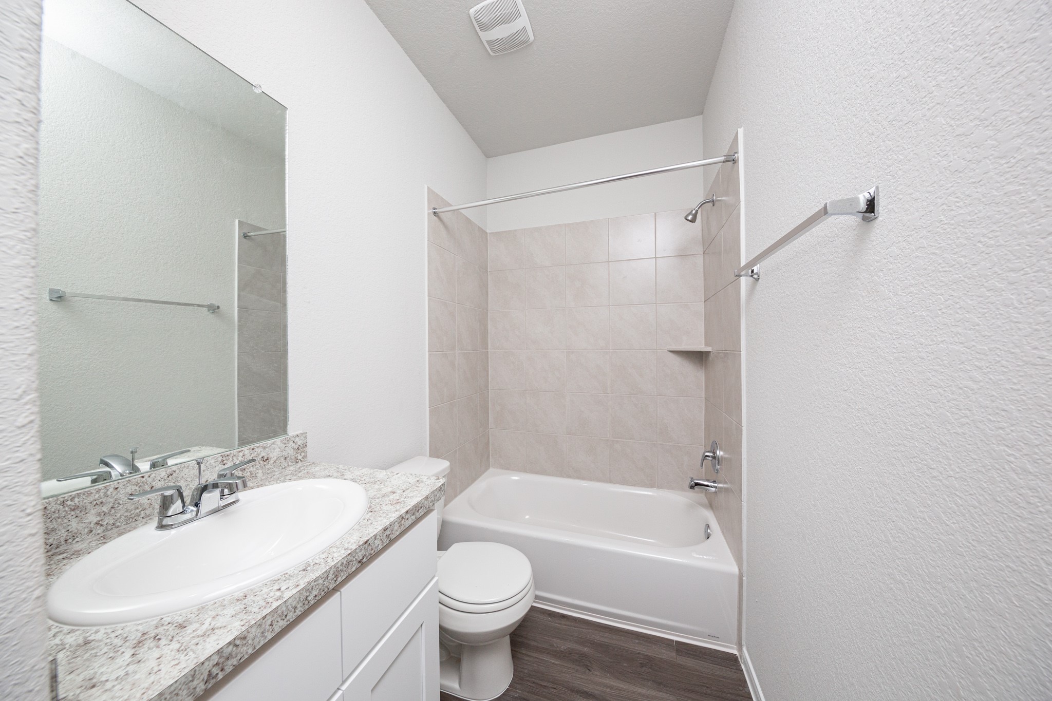 15627 Tranquil Pines Street Conroe, TX 77302 - Photo 6 of 27 a bathroom with a granite countertop sink toilet mirror and bathtub