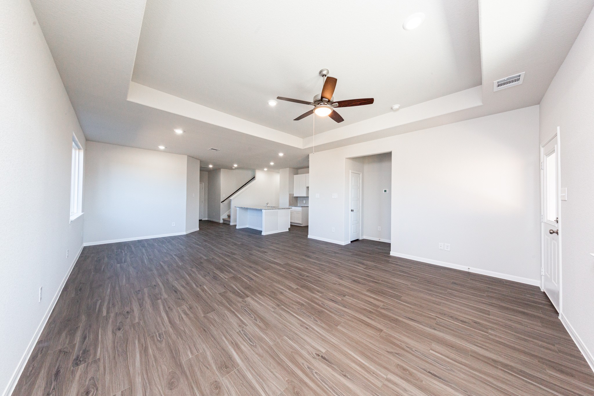 15627 Tranquil Pines Street Conroe, TX 77302 - Photo 10 of 27 a view of empty room with wooden floor and fan
