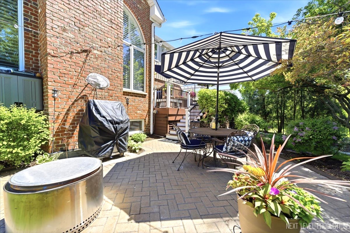 1914 North Ridge Avenue Arlington Heights, IL 60004 - Photo 43 of 50 a view of a patio with table and chairs potted plants and wooden fence