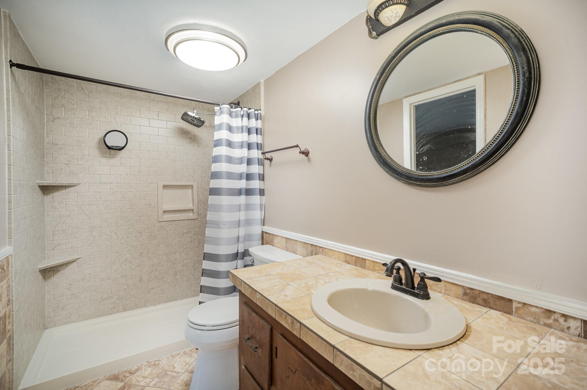 110 Hidden Valley Cherryville, NC 28021 - Photo 11 of 23 a bathroom with a sink a toilet and a mirror