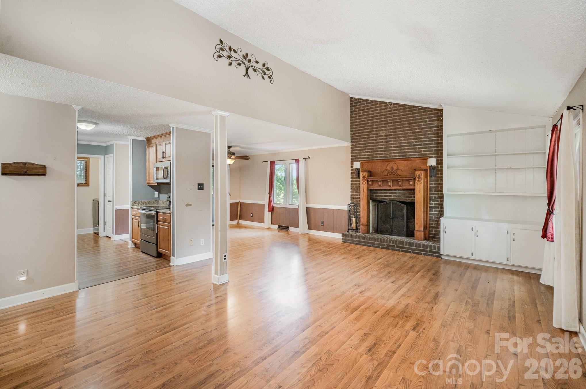 110 Hidden Valley Cherryville, NC 28021 - Photo 11 of 23 an empty room with wooden floor and fireplace