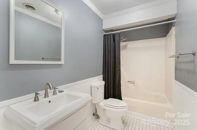 a white toilet sitting next to a bathroom sink
