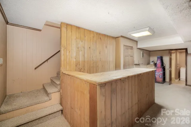 a view of entryway with kitchen and hall