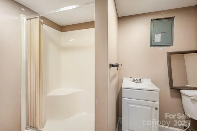 a bathroom with a sink toilet and shower