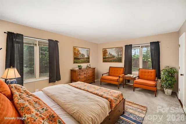 a bedroom with a bed and glass window