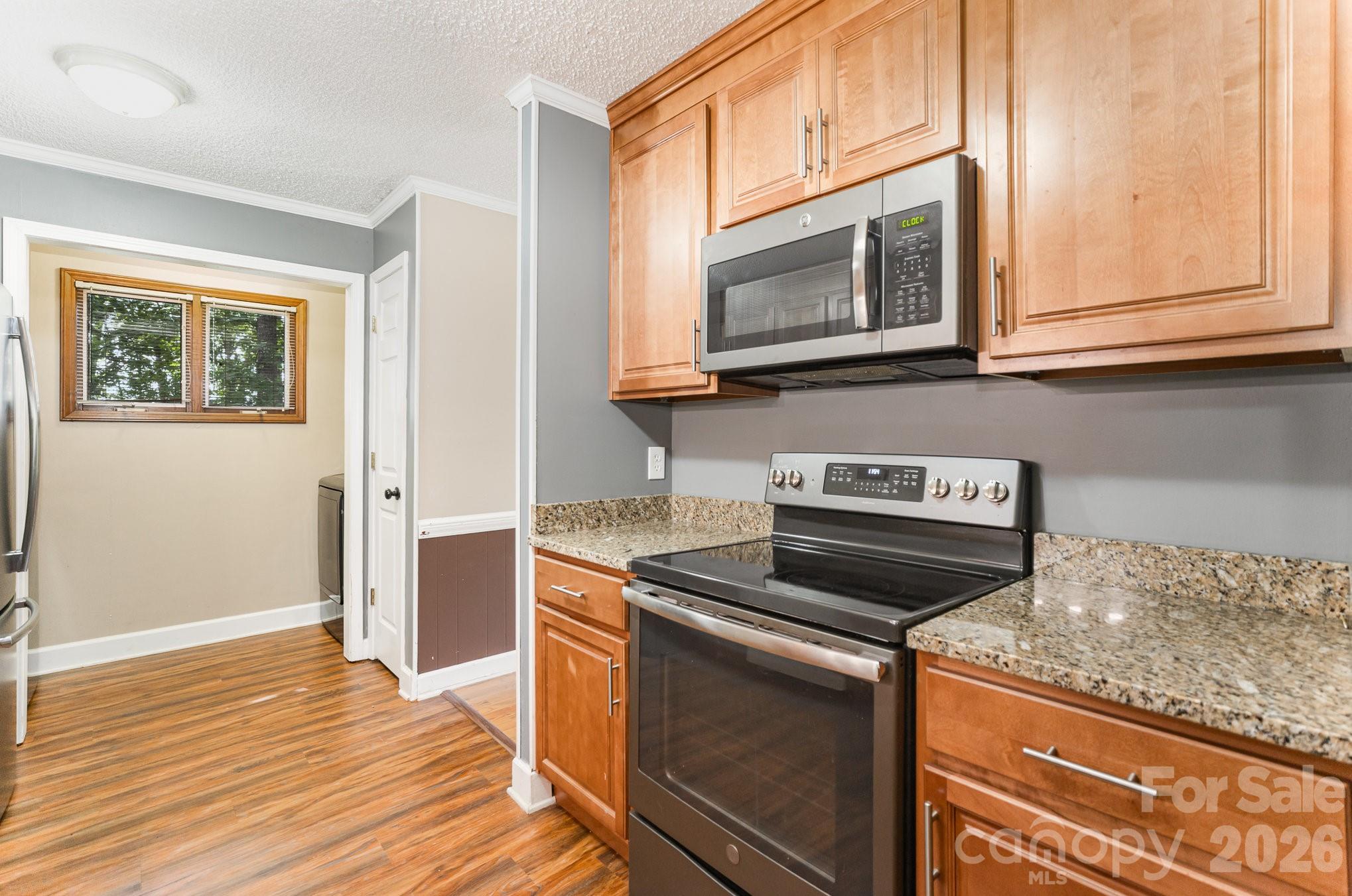110 Hidden Valley Cherryville, NC 28021 - Photo 5 of 23 a kitchen with granite countertop a stove microwave and sink