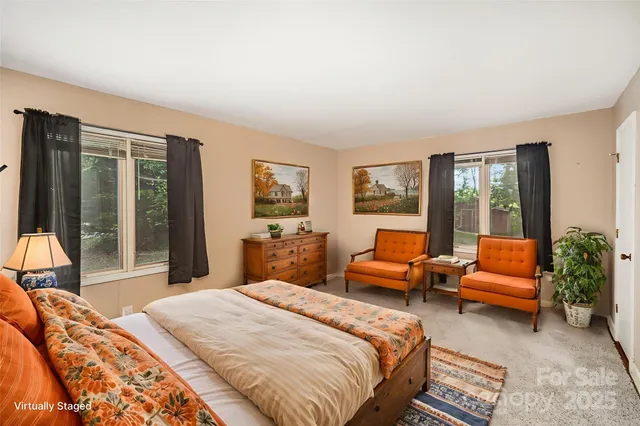 a bedroom with a bed and glass window