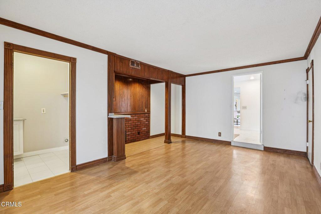 10856 Topeka Drive Porter Ranch, CA 91326 - Photo 17 of 40 a view of an empty room with wooden floor and a window