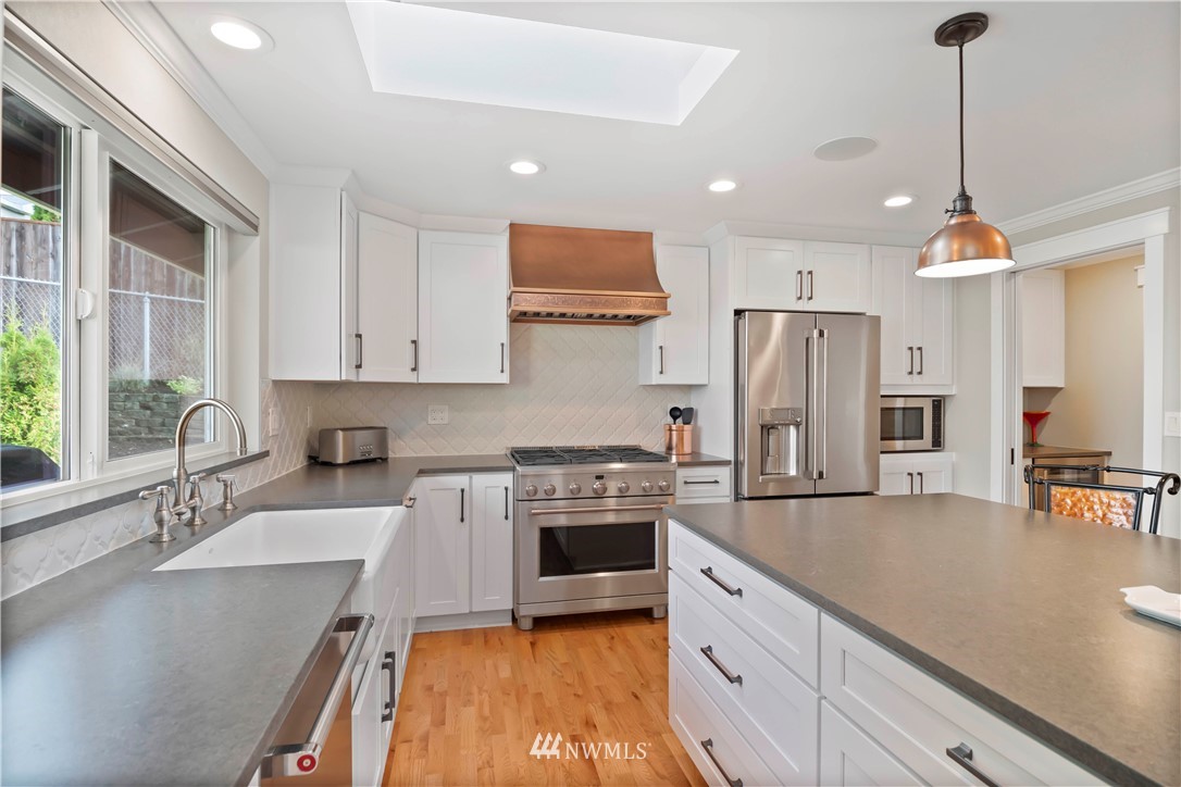 10404 Northeast 197th Street Bothell, WA 98011 - Photo 13 of 29 a kitchen with stainless steel appliances granite countertop a sink stove and refrigerator